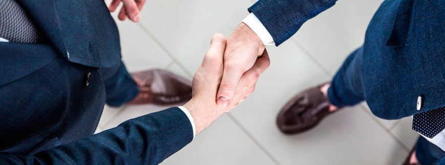 Un grupo de hombres de negocios se dan la mano en una oficina.
