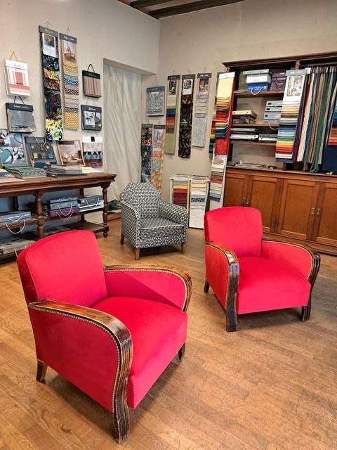 2  fauteuils rouges et un fauteuil noir et blanc