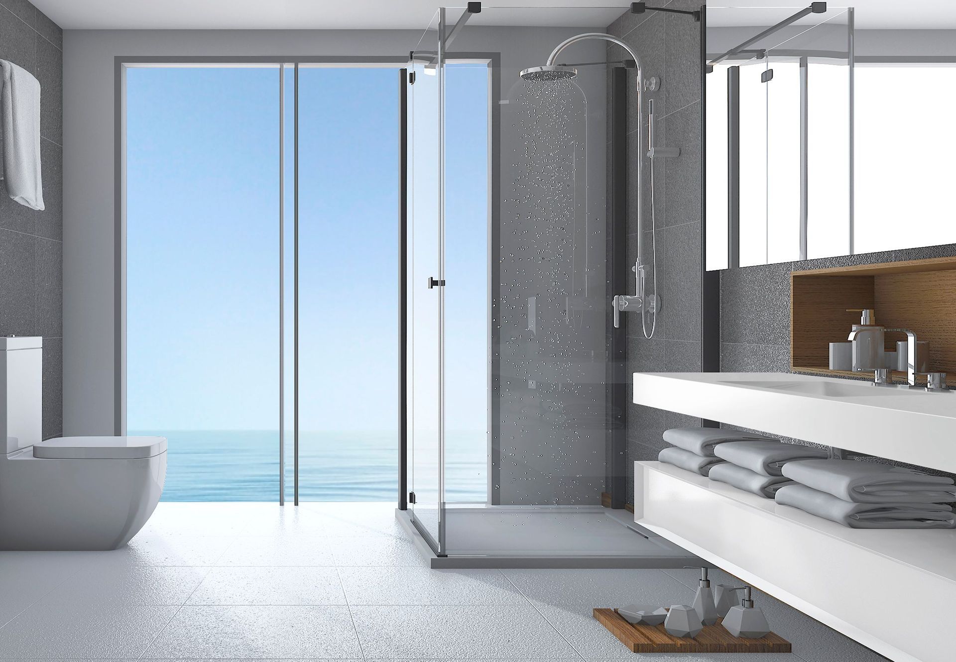 Un baño con inodoro, lavabo y ducha con vista al océano.