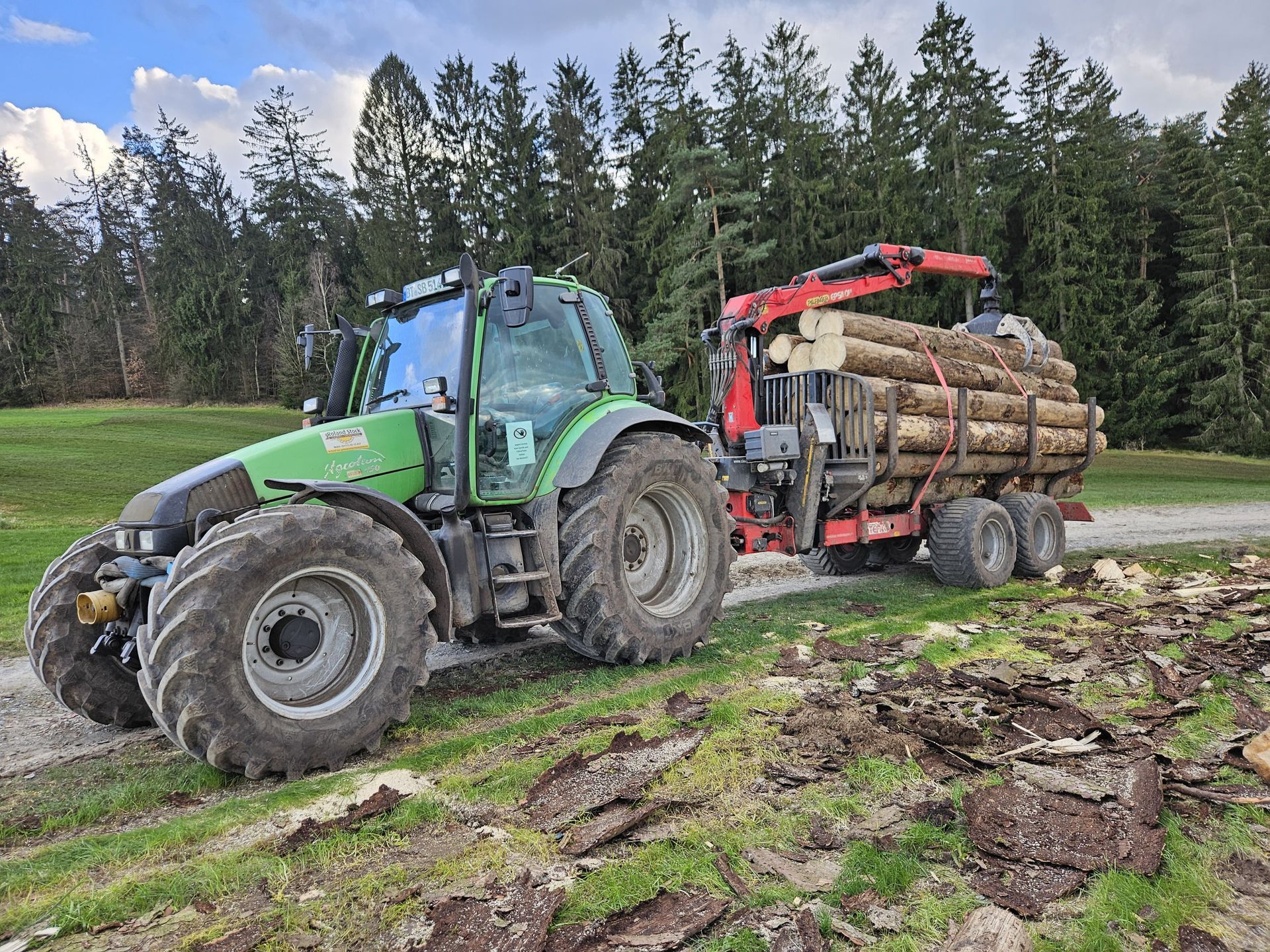 Zwei Traktoren mit Holzrückewagen im Wald