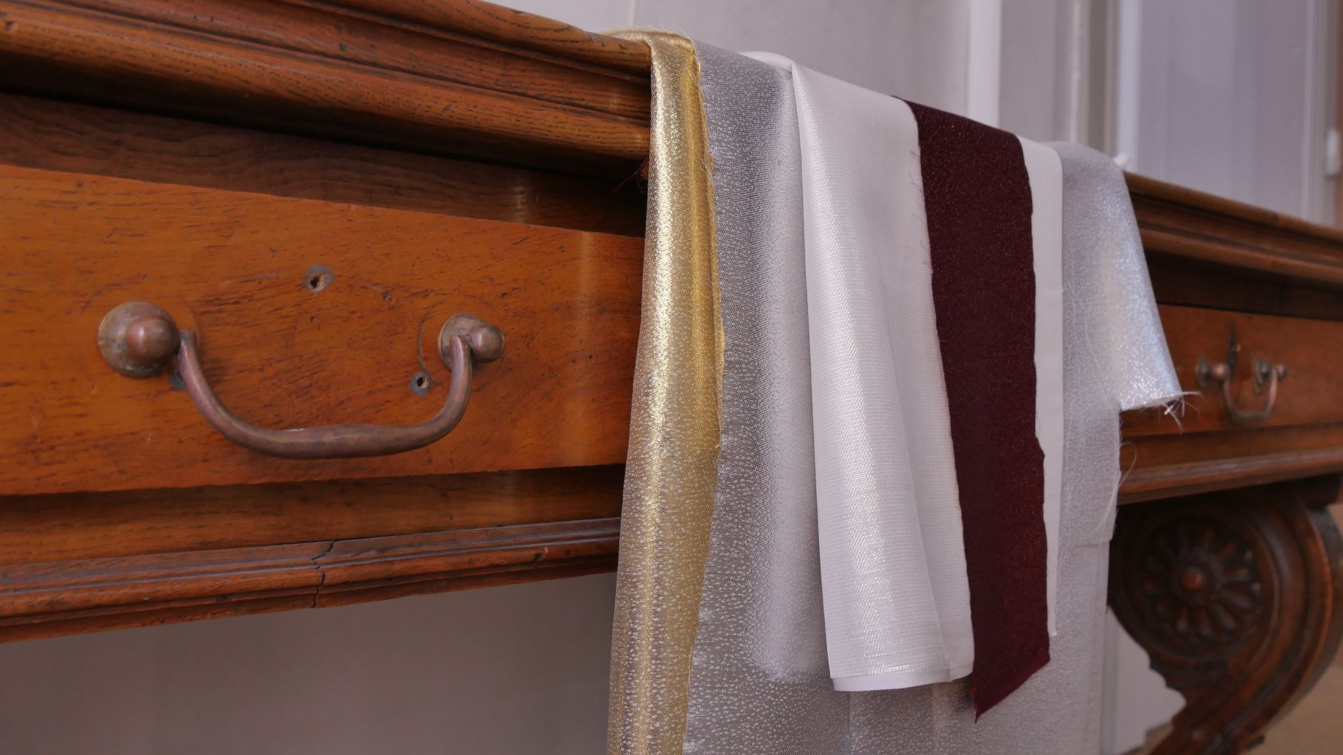 Nœud en ruban de satin blanc avec une petite étiquette suspendue sur une surface tissée.