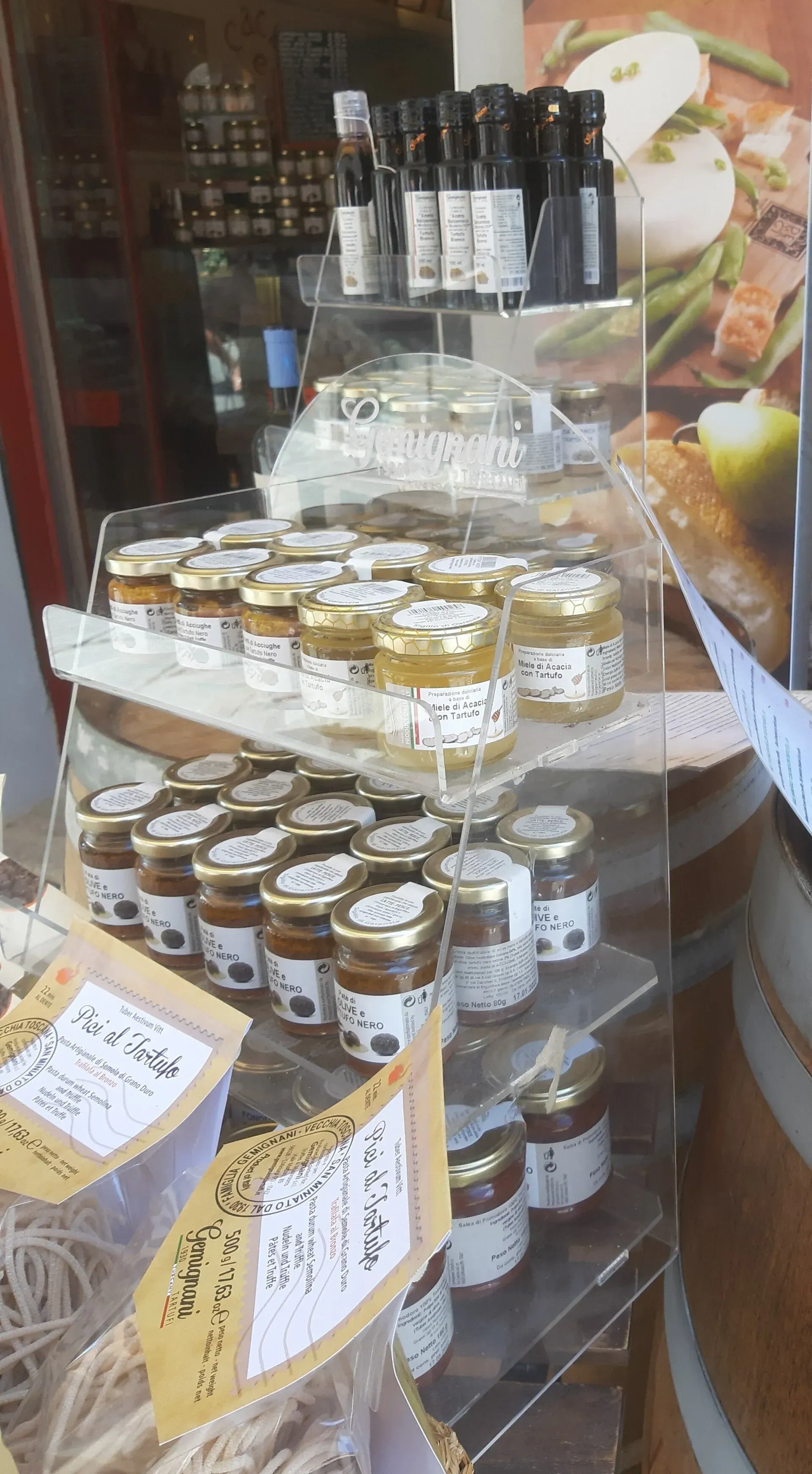 Una exhibición de frascos y botellas de comida en el escaparate de una tienda.