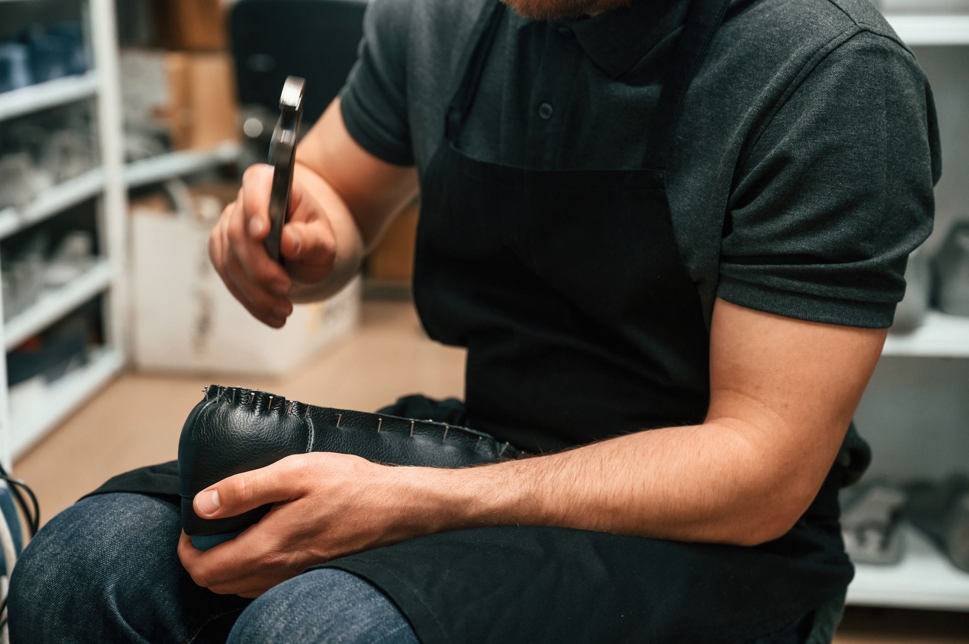 Professionnel réparant une chaussure orthopédique en remplaçant une semelle usée