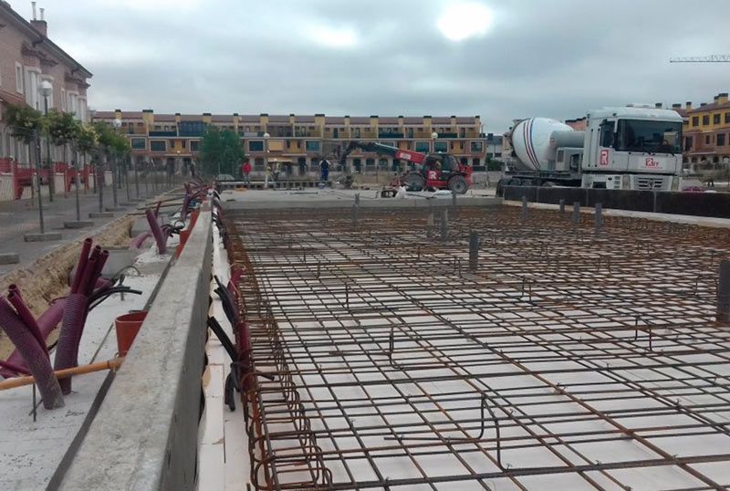 Un camión hormigonera está vertiendo hormigón en una obra de construcción