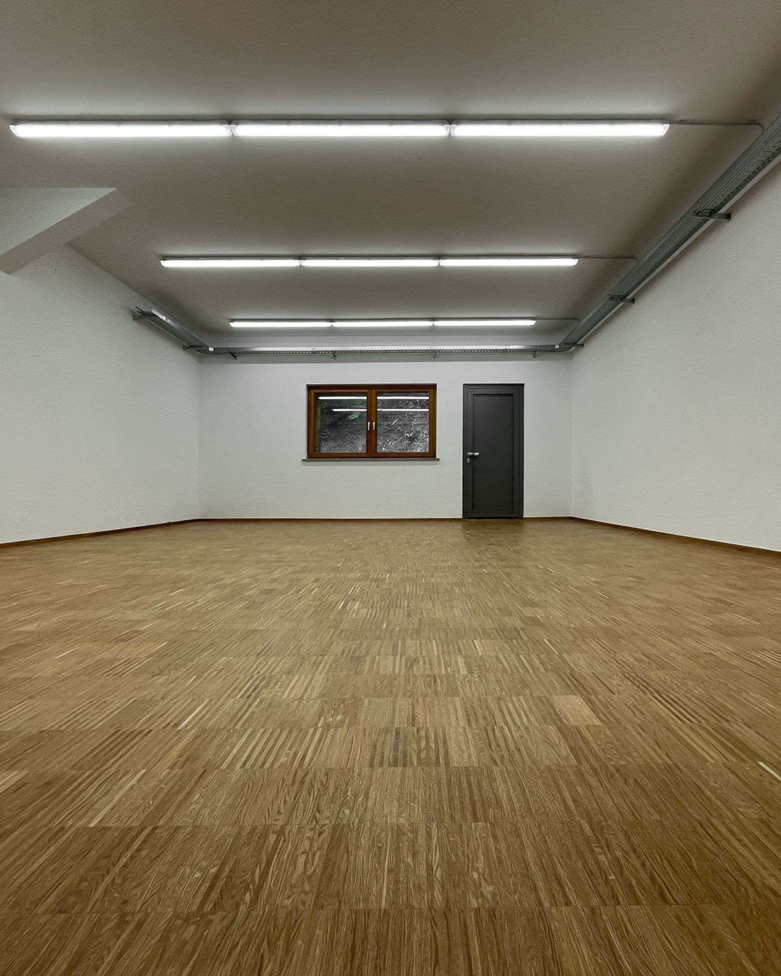 Großzügiger Raum mit hochwertigem Parkettboden von Schreinerei Tritschler saniert und verlegt