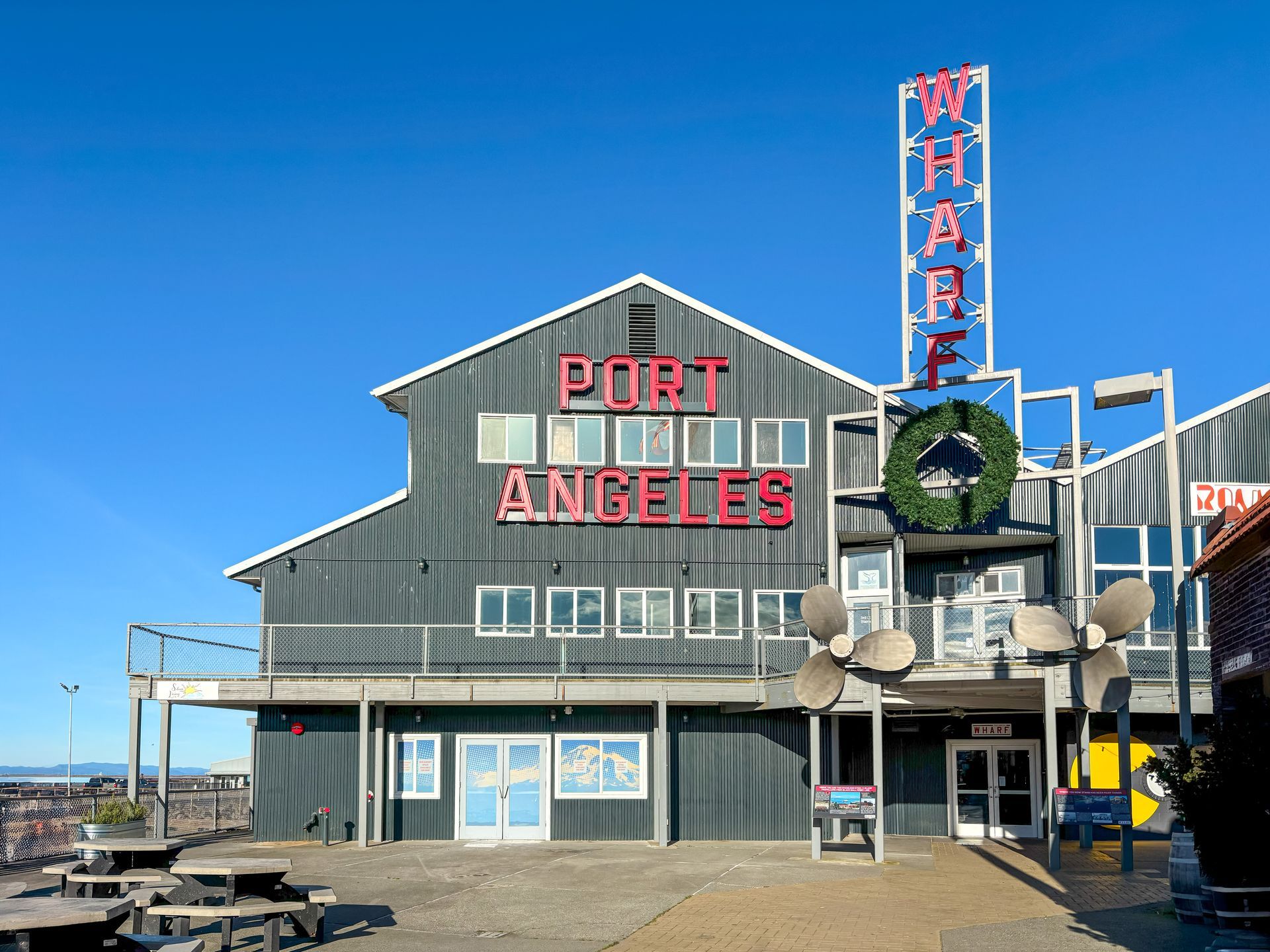 The Port Angeles Wharf building with red letters and a large