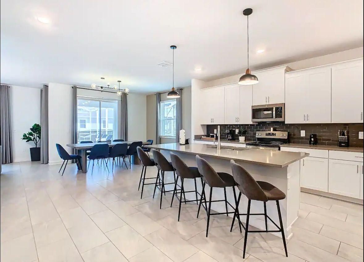 A large kitchen with a long island and stools