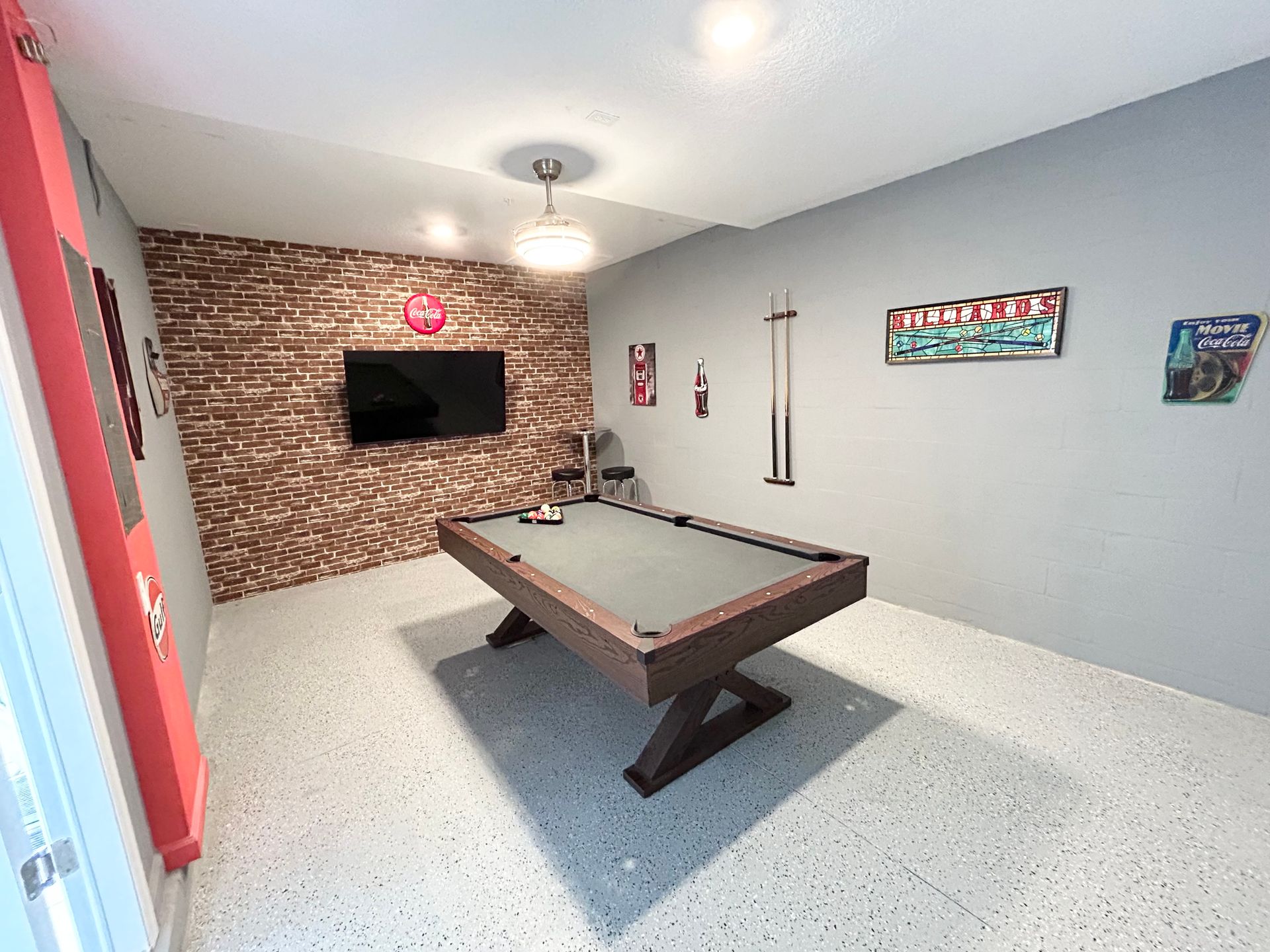 There is a pool table in the middle of the room.