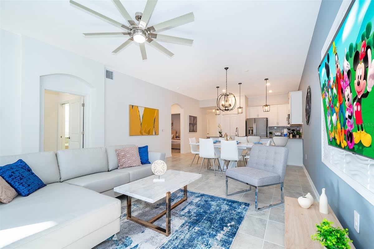 A kitchen in a house with white cabinets and stainless steel appliances.
