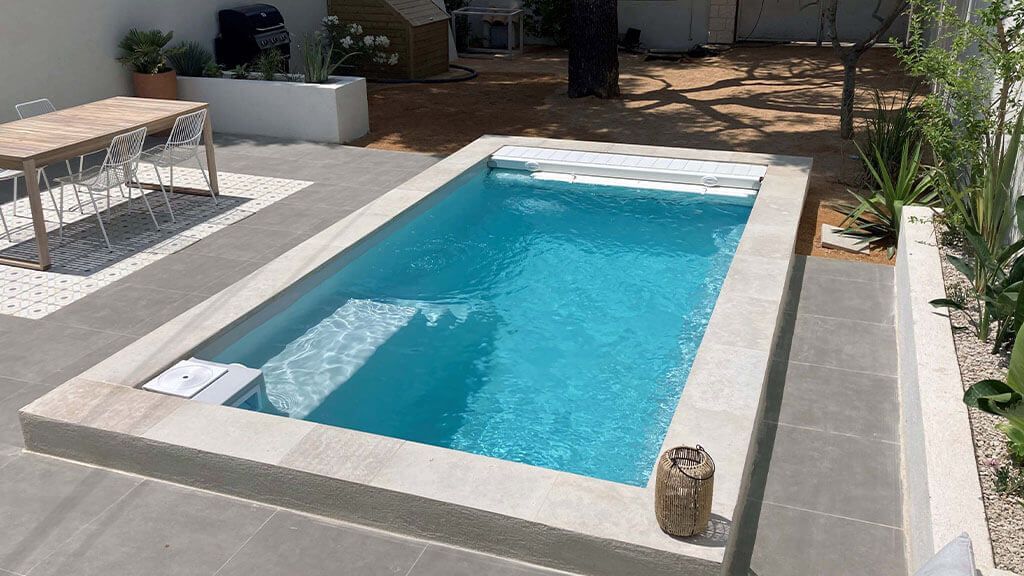 Une terrasse avec une piscine et une table de jardin
