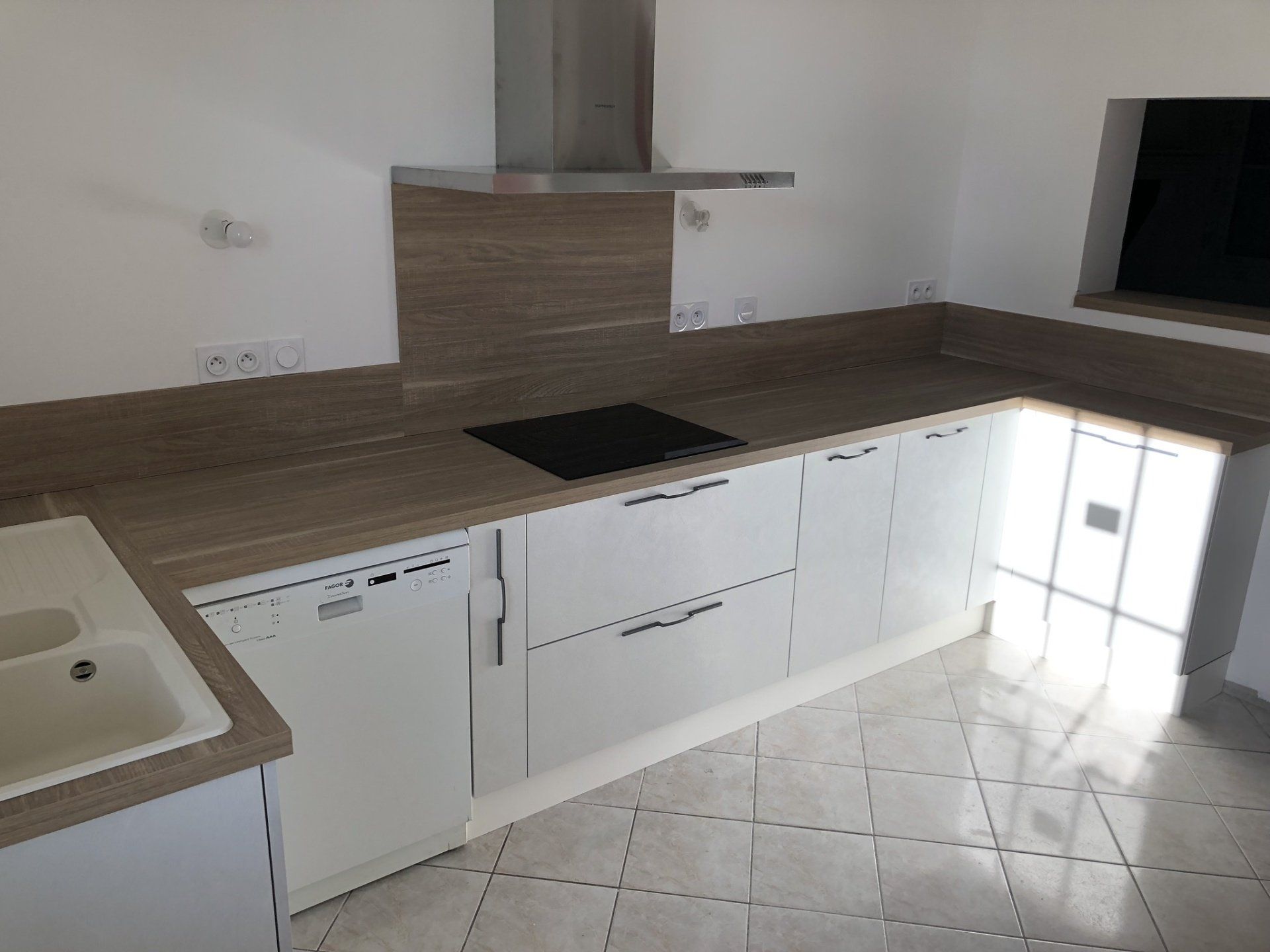 Photo d'une cuisine avec des rangements moderne et plan de travail en bois, lave vaiselle.