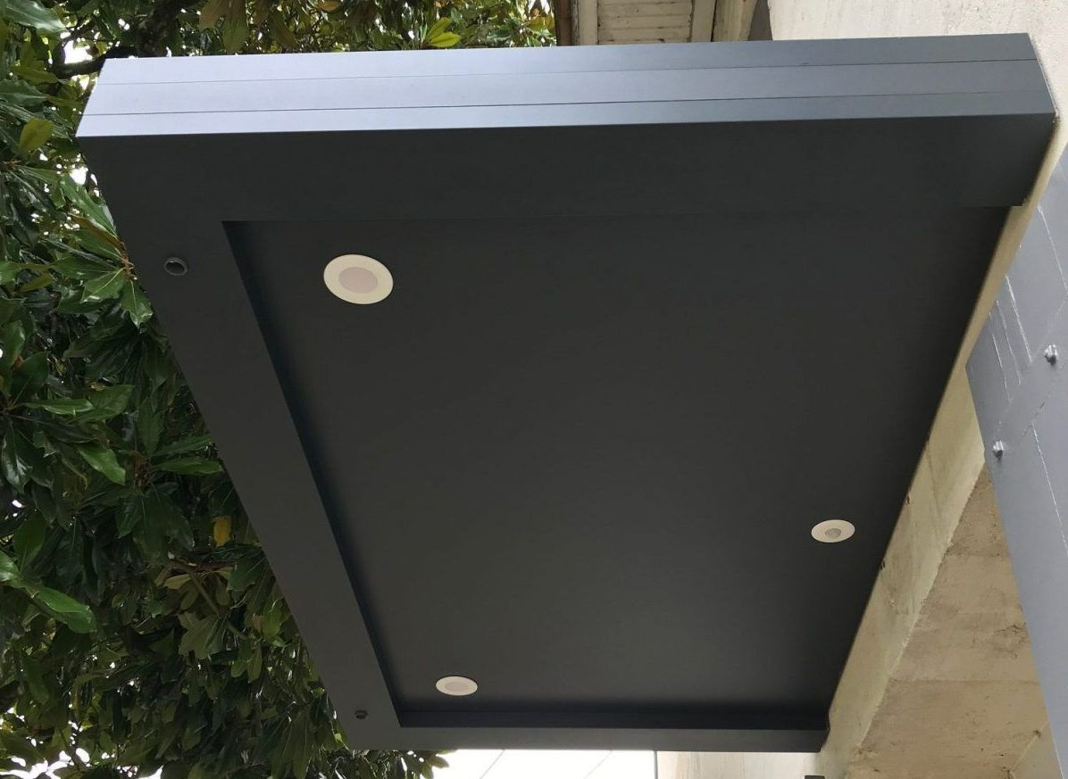Marquise de protection au-dessus d'une porte d'entrée.