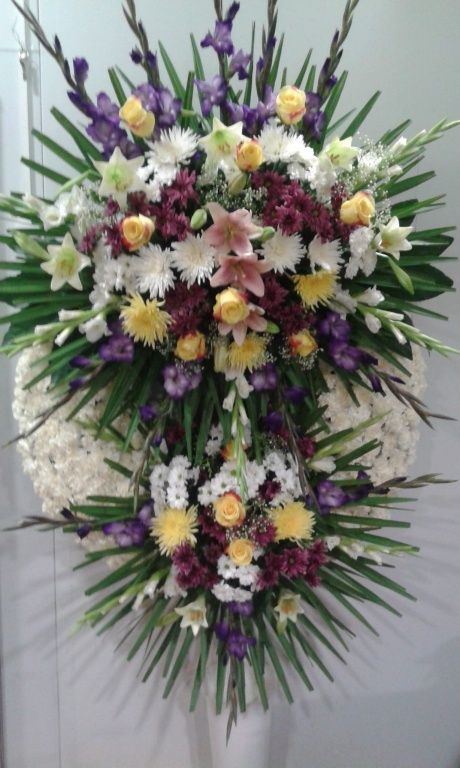 Una gran exhibición de flores moradas y blancas en un soporte.