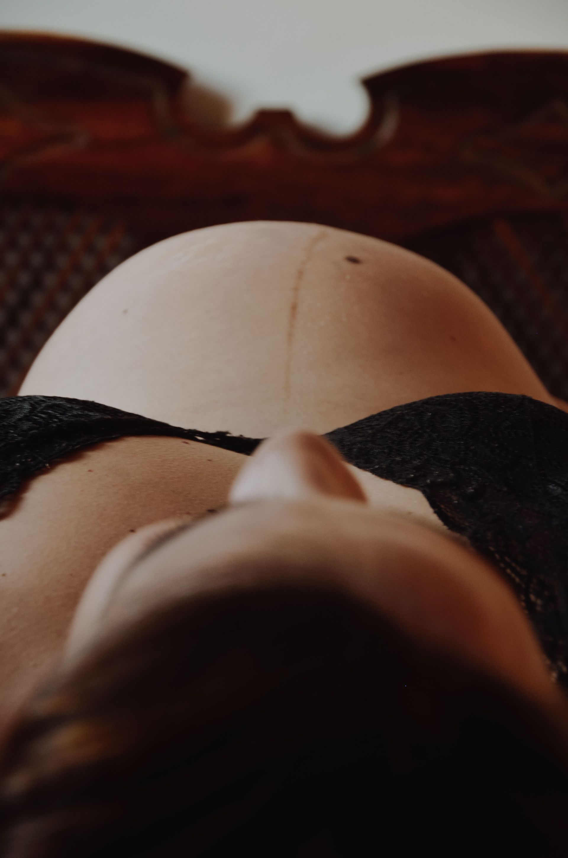 Gros plan sur le visage d'une poupée avec un bandeau noir sur fond de bois sombre