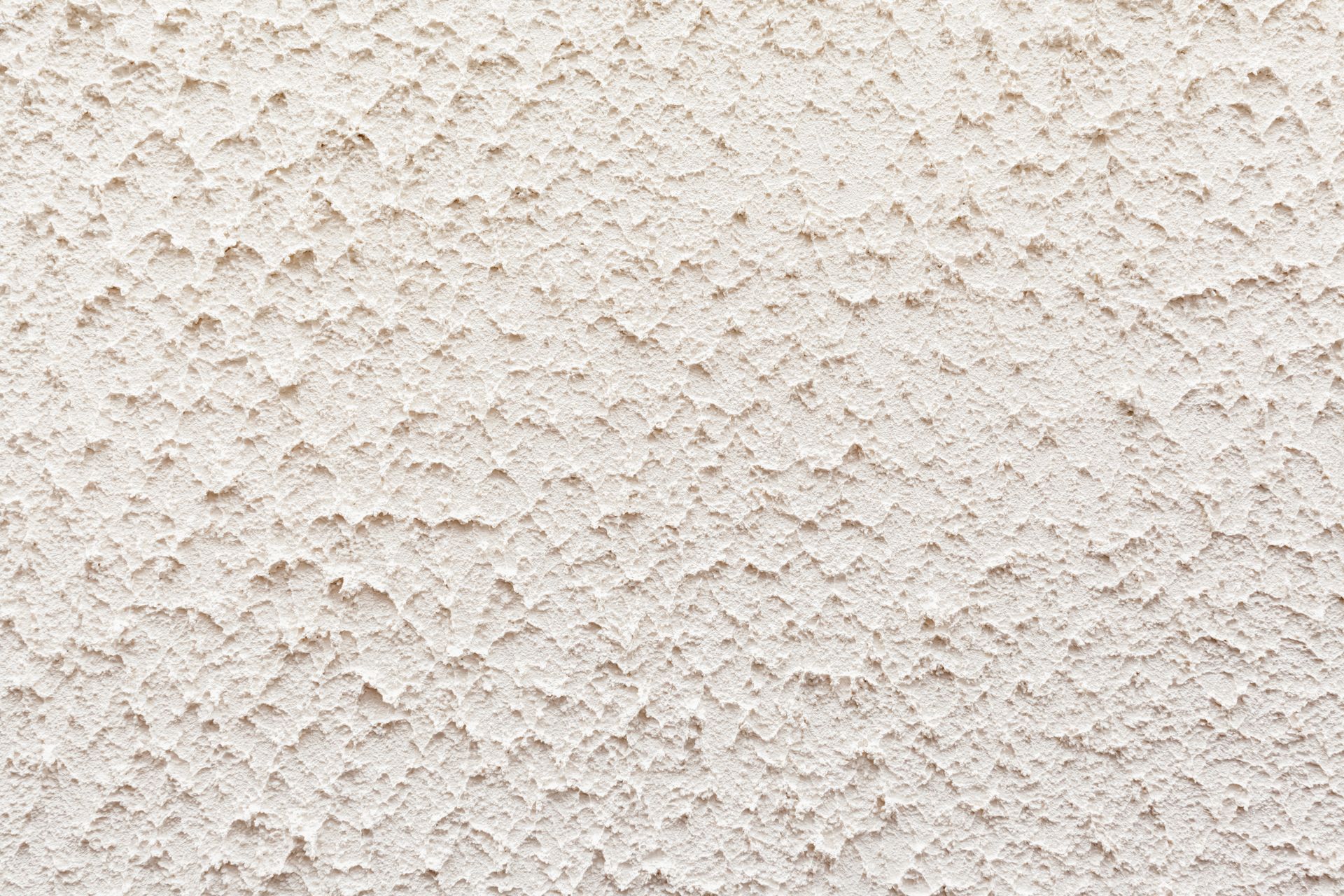 Gros plan sur un mur texturé blanc cassé