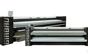 Dues planxadores de roba per a bugaderia industrial de Girbau, en blanc i negre amb rodets metàl·lics.