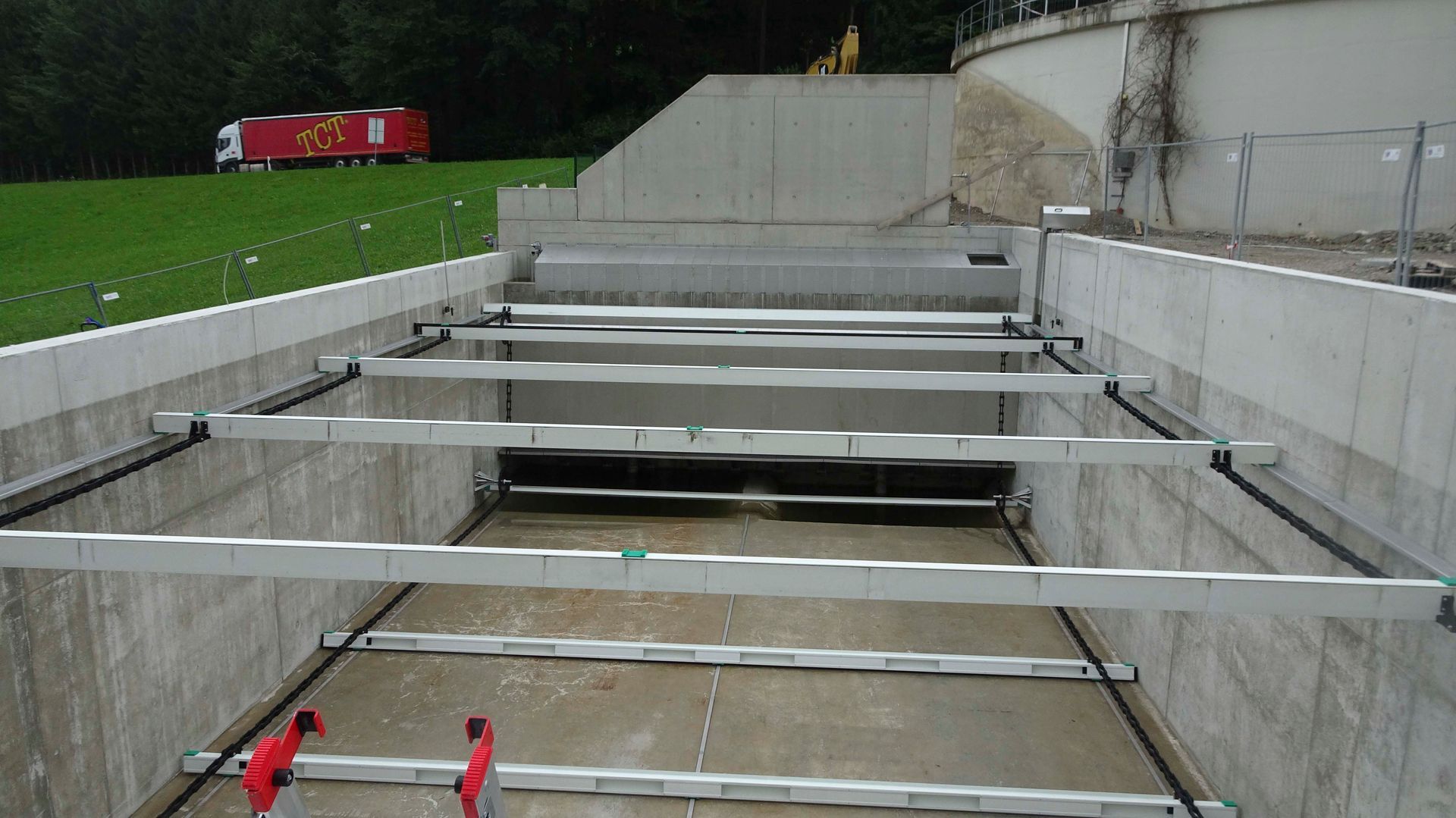 Im Hintergrund einer Baustelle parkt ein roter LKW
