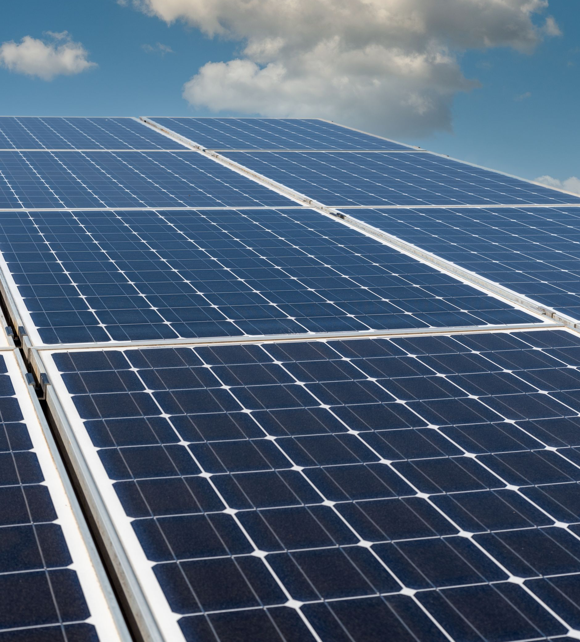 Des panneaux solaires sur un toit, des cellules avec des lignes de grille blanches.