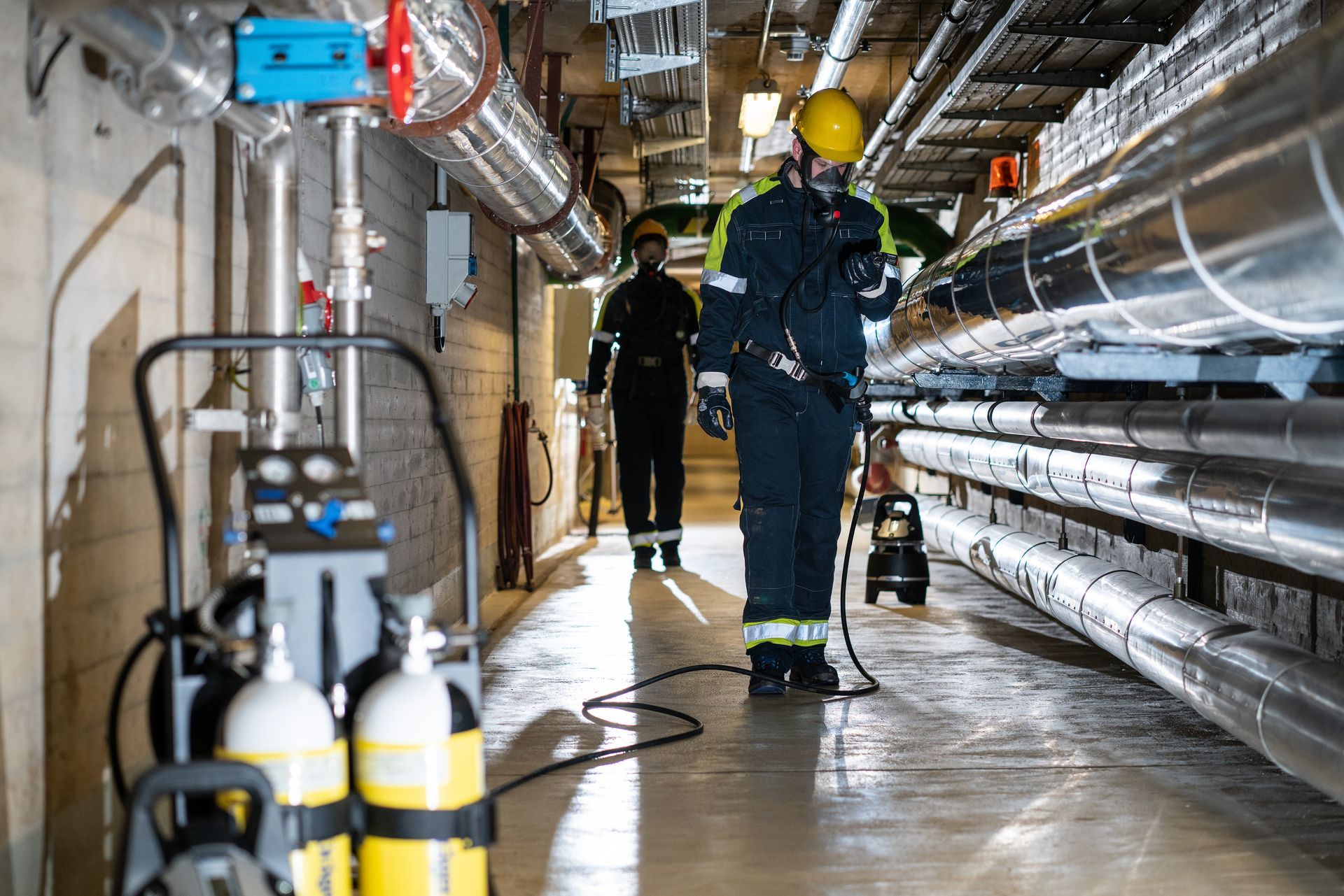 Atemschutztrupp im Einsatz mit Pressluftflaschen in Industrieanlage für Sicherheit