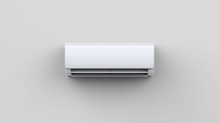 Climatiseur mural blanc sur un mur gris clair