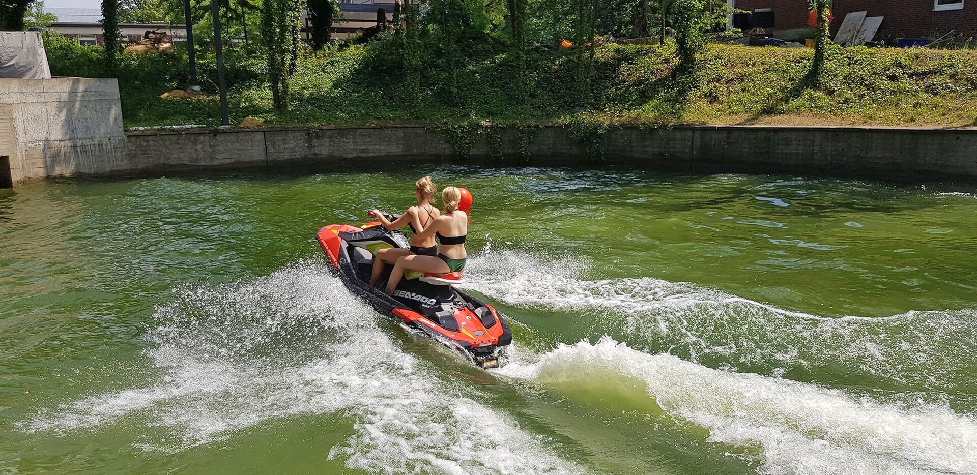 Ein paar Leute fahren Jetski auf einem See.