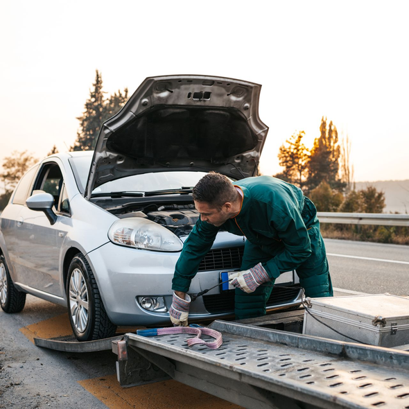 Une voiture est remorquée par un professionnel.