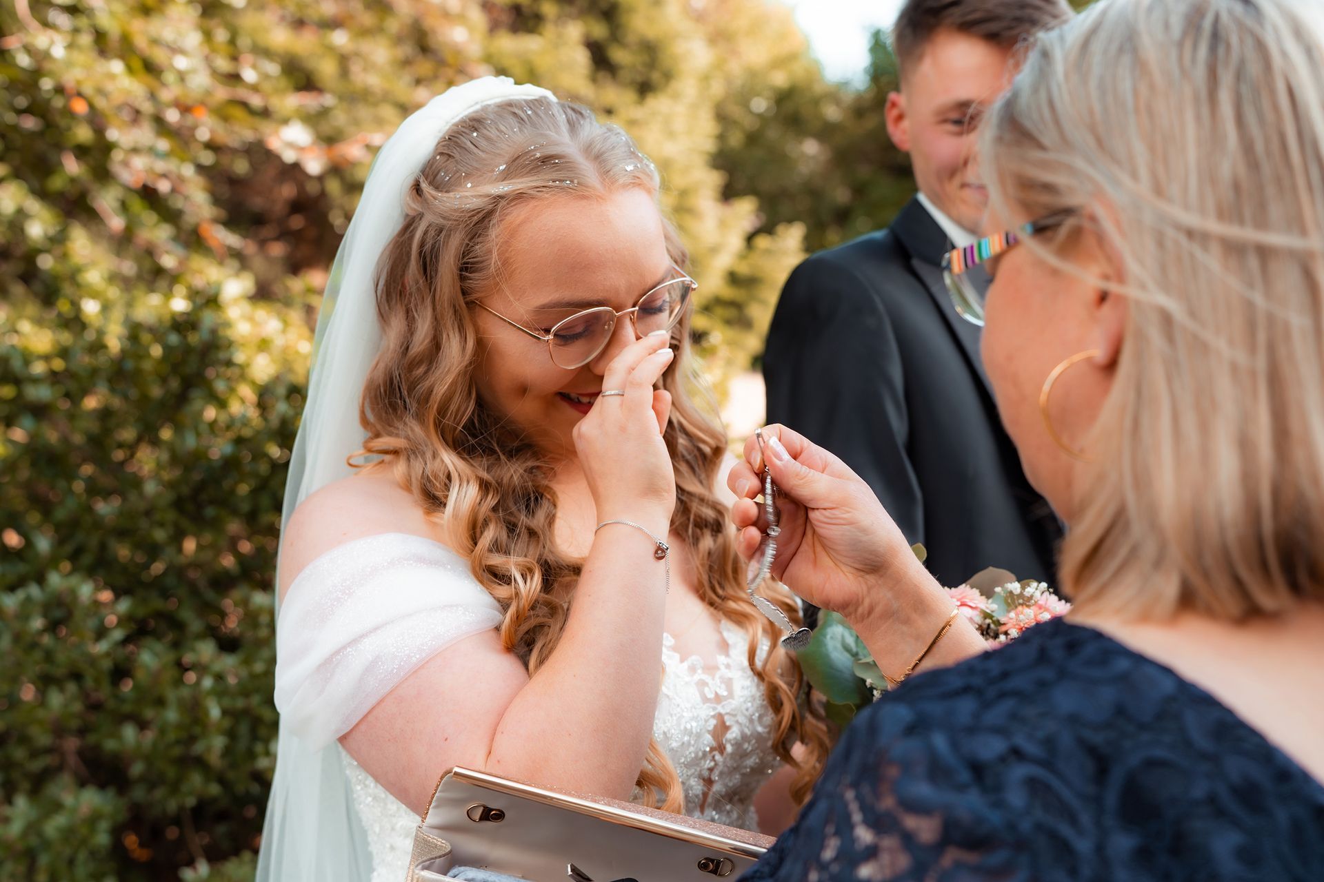 Emotionale Gratulationsszene, bei der die Braut mit Tränen in den Augen eine Umarmung nach der Trauung in Bremen erhält.