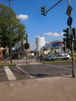 Eine belebte Kreuzung mit am Straßenrand geparkten Autos