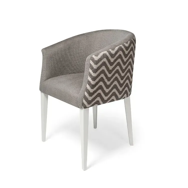 Una silla con un patrón de chevrones en el respaldo y patas blancas.