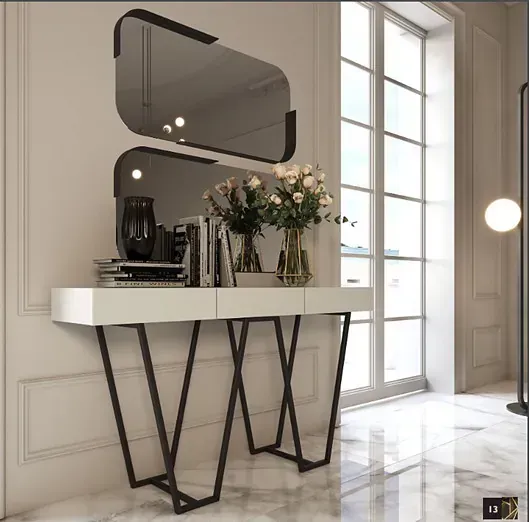 Una mesa blanca con un espejo y flores encima.