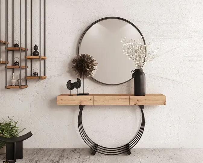 Una consola de madera con un espejo redondo encima.