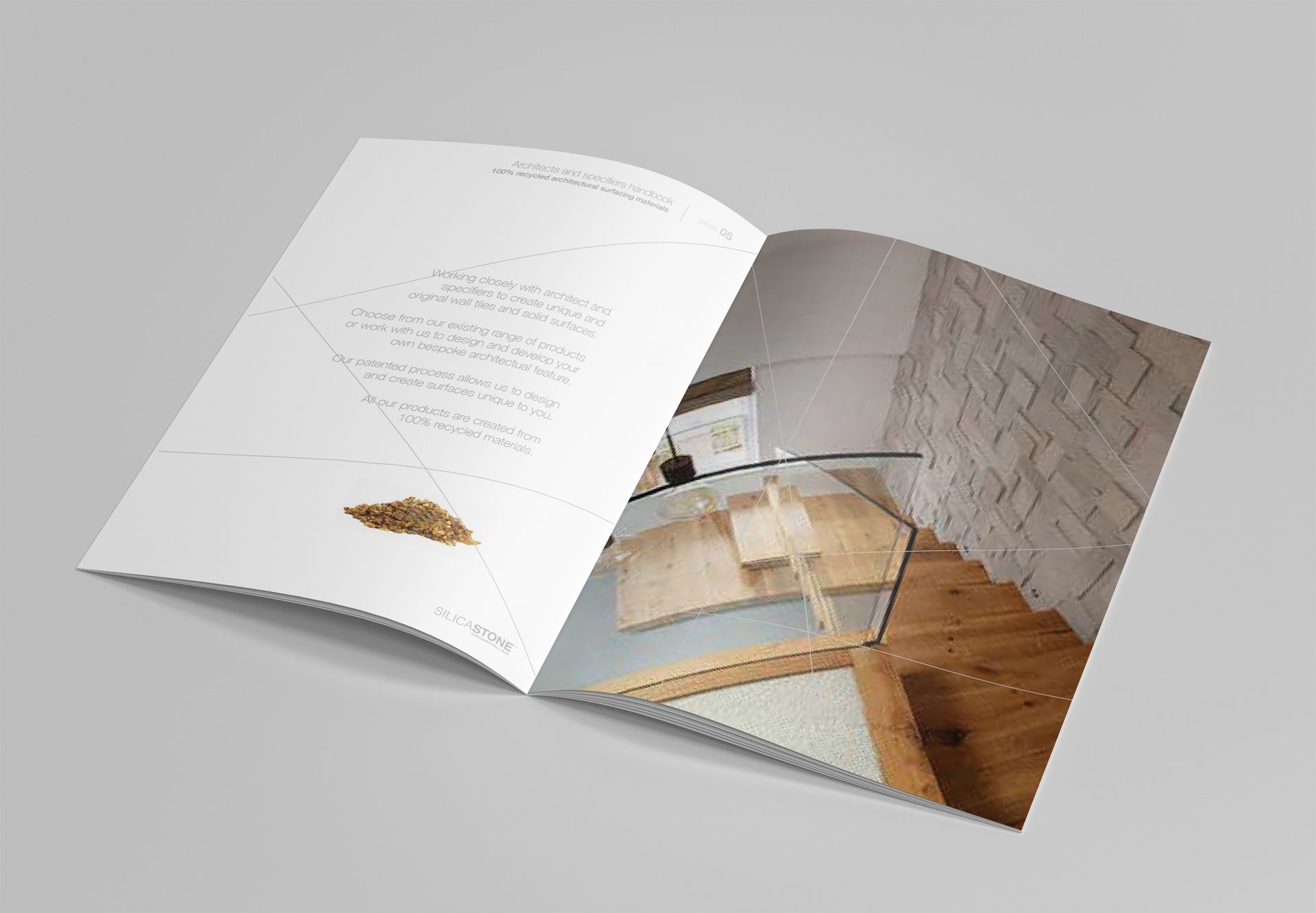 An open brochure showing text on the left page and an interior design mockup with wood flooring and stone walls on the right.