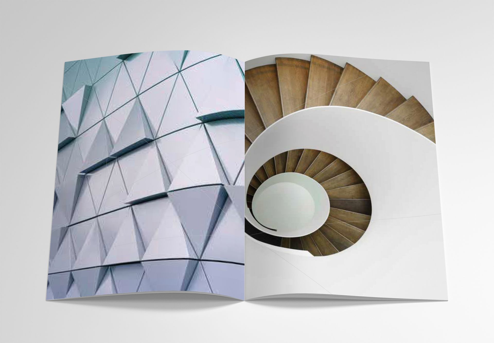 An open magazine spread featuring a geometric, triangular building facade on the left and a spiral staircase on the right.