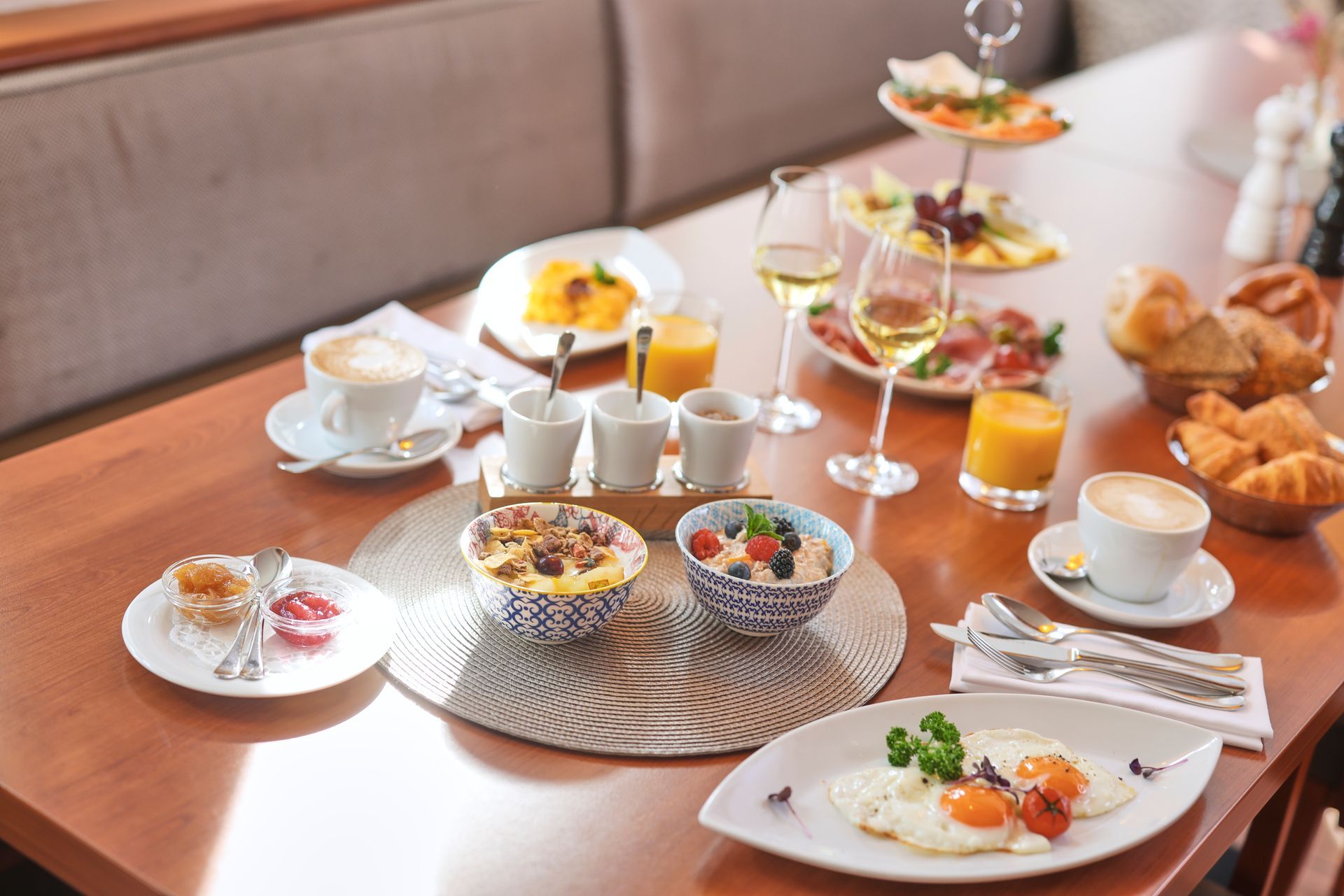 Frühstückstisch: Eier, Gebäck, Obst, Käse, Saft, Kaffee und Champagner.