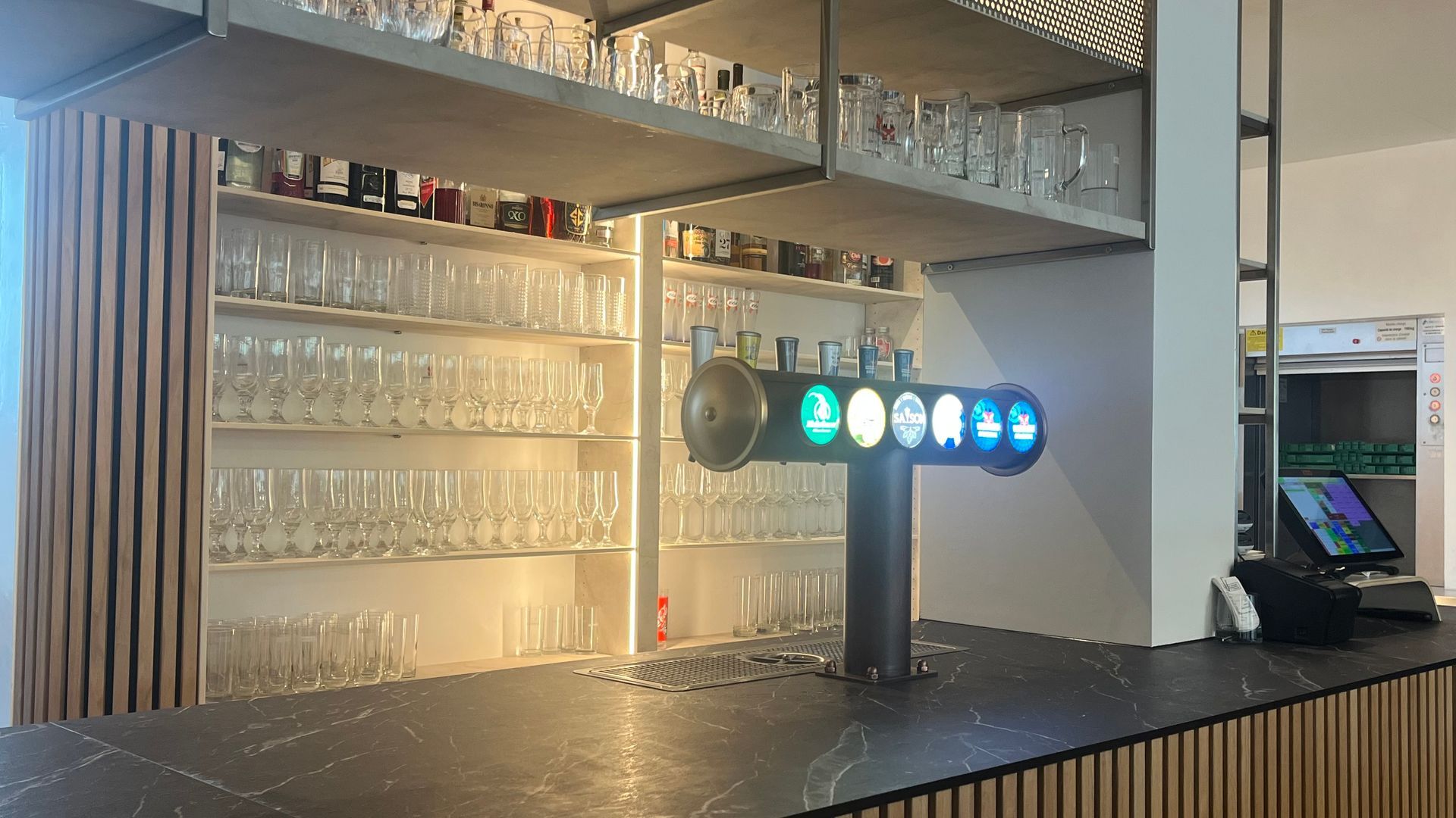 Un bar avec beaucoup de verres et une pompe à bière.