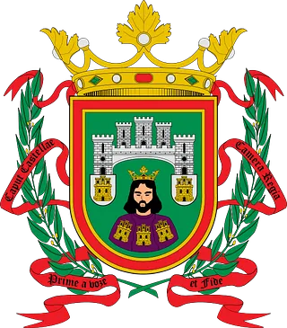 Escudo de armas cívico colorido con corona, castillo, corona de laurel y estandartes de cintas sobre fondo blanco.