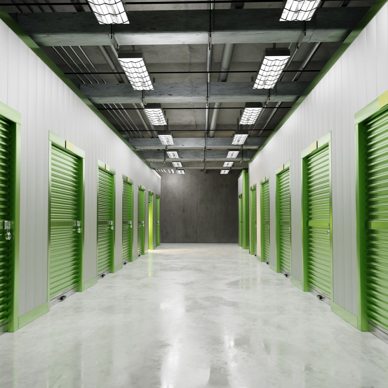 Un couloir lumineux dans un entrepôt de stockage, avec des portes roulantes métalliques vertes de chaque côté.