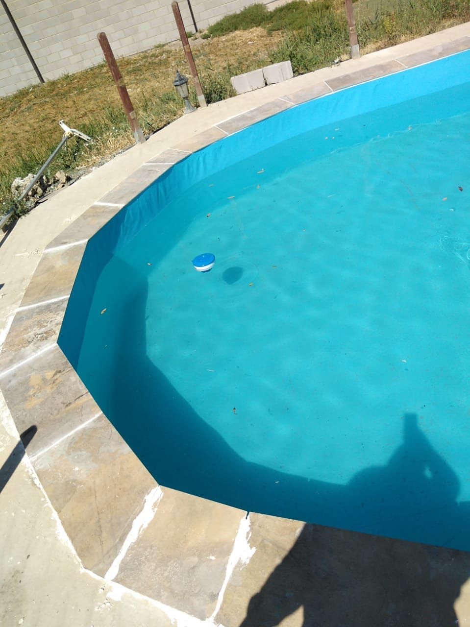 Una piscina azul con una pelota azul dentro