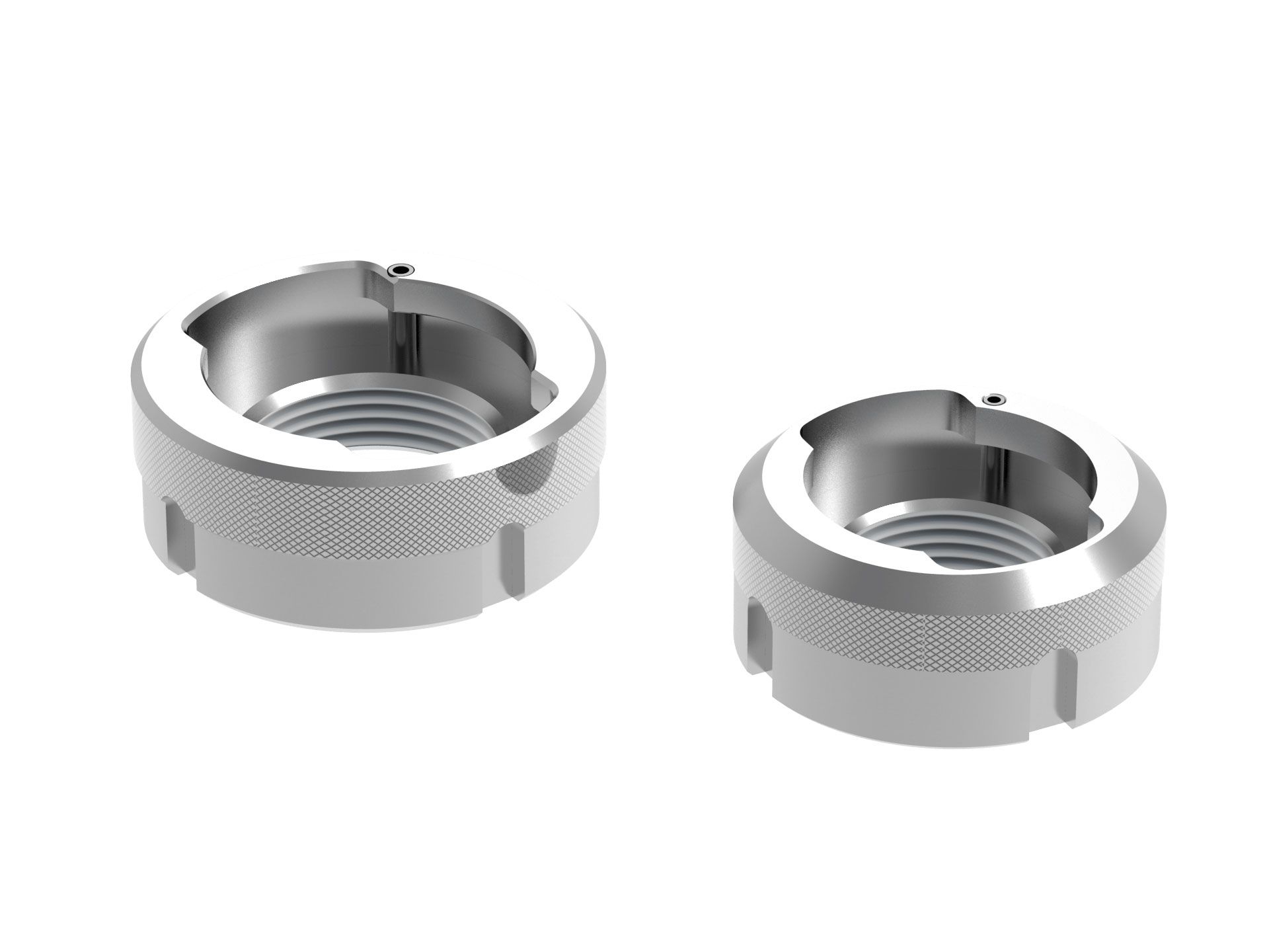 Ein Paar Edelstahlmuttern auf weißem Hintergrund.