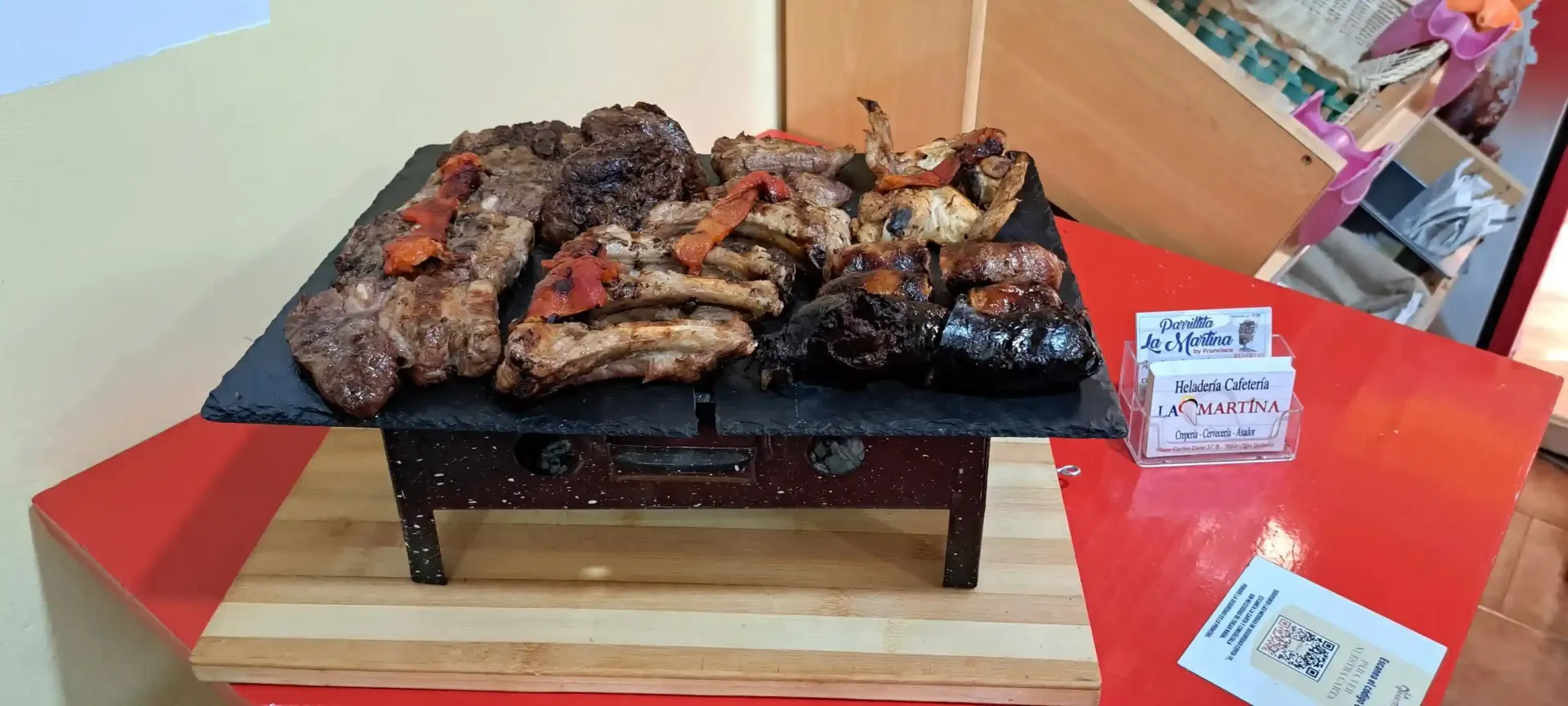 Un filete a la parrilla, chamuscado, chisporroteando sobre las llamas en una barbacoa.