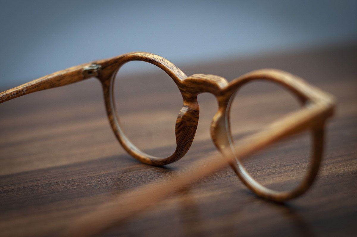 Lunettes en bois posées sur une surface en bois, gros plan avec une faible profondeur de champ.
