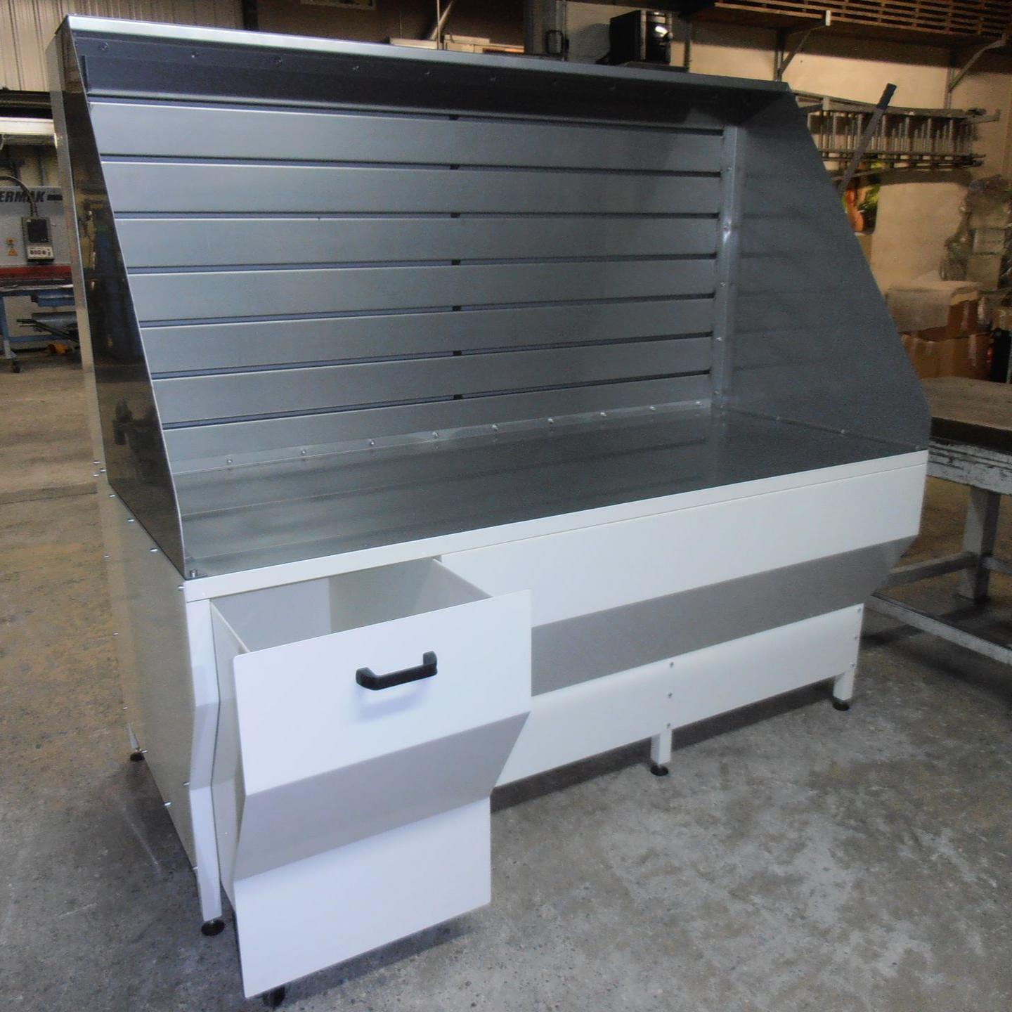 Poste de travail commercial en acier inoxydable et blanc avec tiroir de rangement.