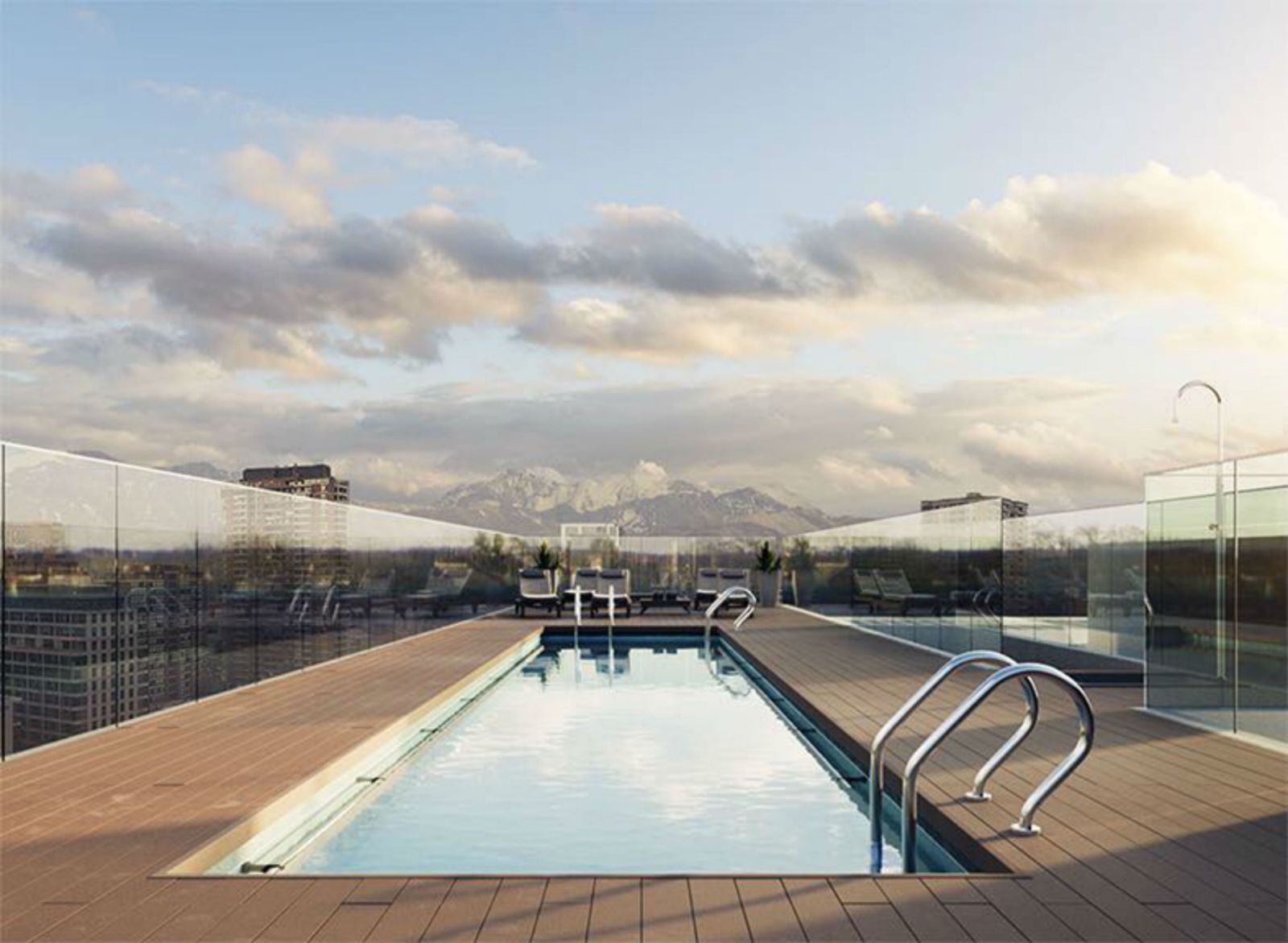 Rooftop swimming pool with mountains and cloudy sky in the distance