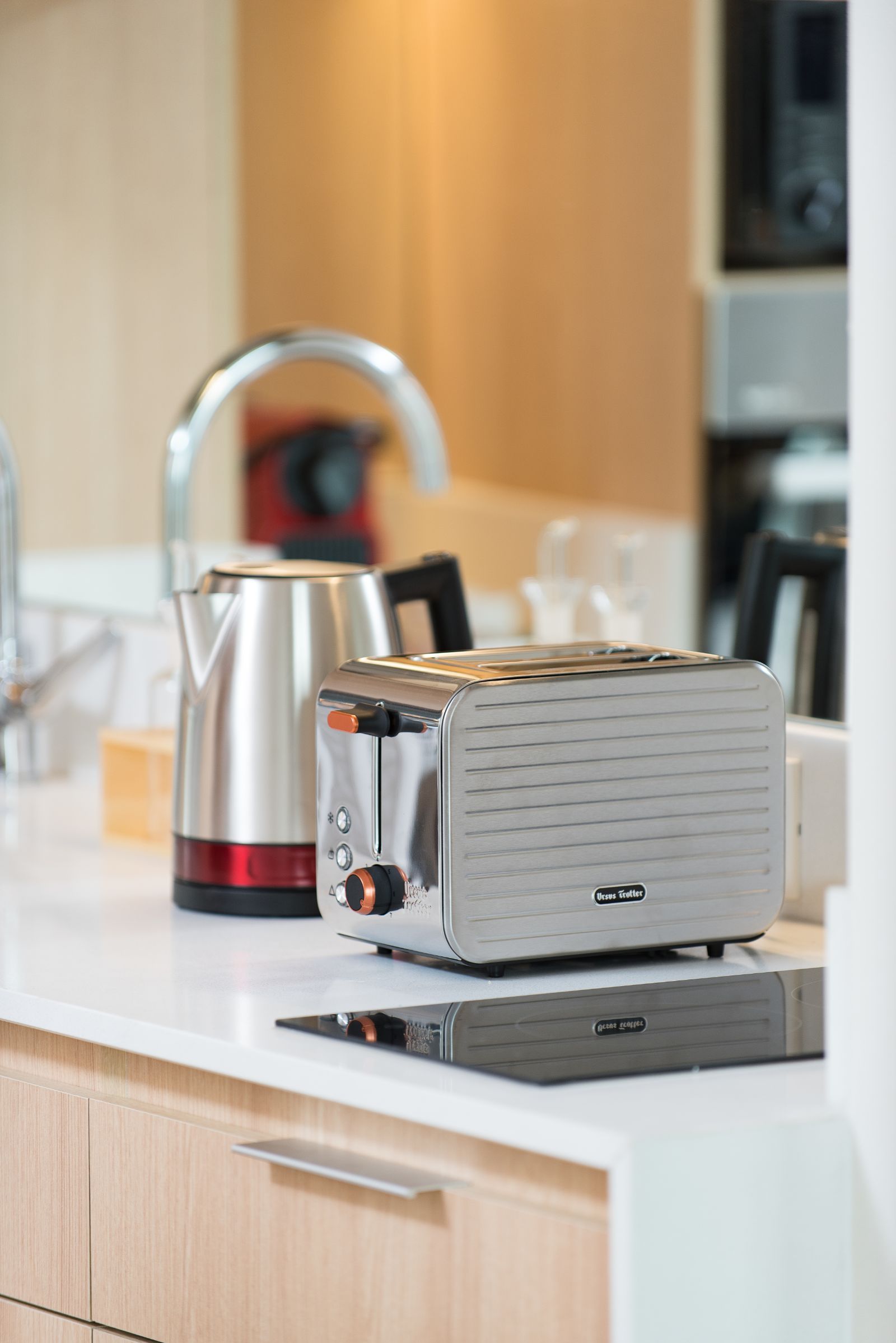 Chrome toaster and electric kettle on a kitchen countertop