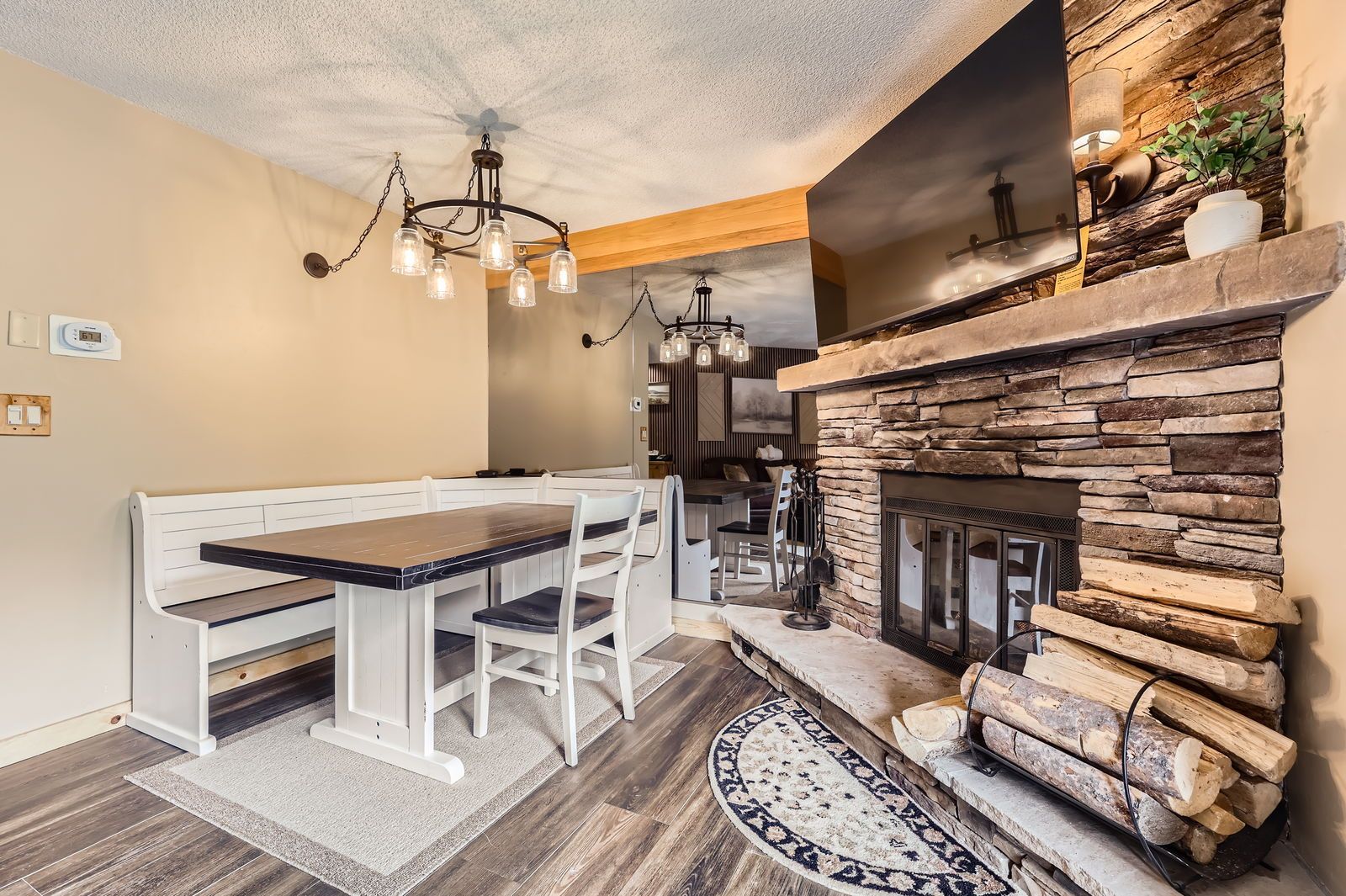 Dining area with a fireplace and built-in bench seating.