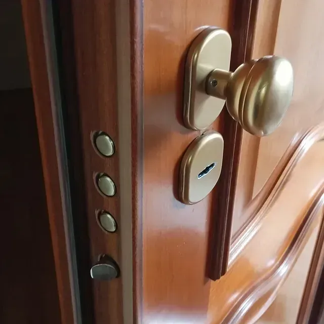 Un primer plano de una puerta de madera con un pomo de latón.