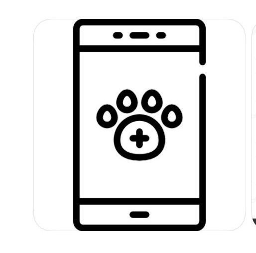 Dos personas con uniformes rosas acarician a un perro en una mesa veterinaria en una sala de exámenes.