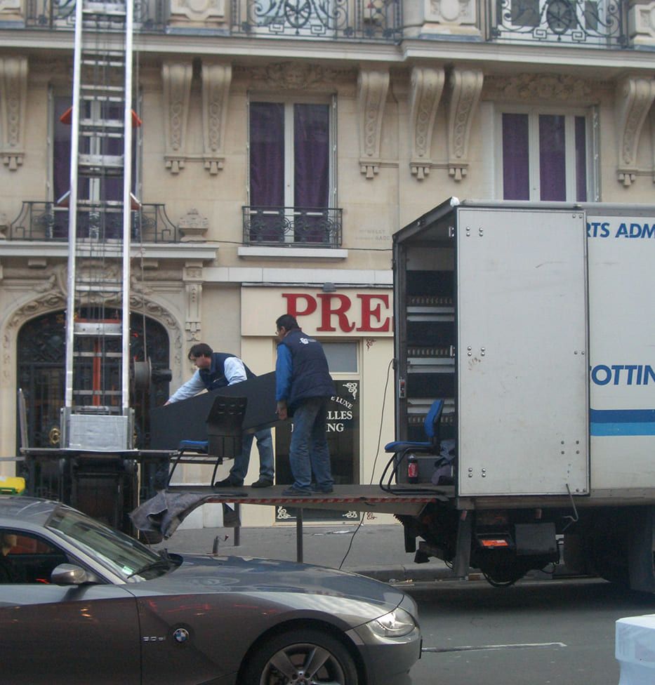 Professionnels du déménagement stationnés dans une rue.