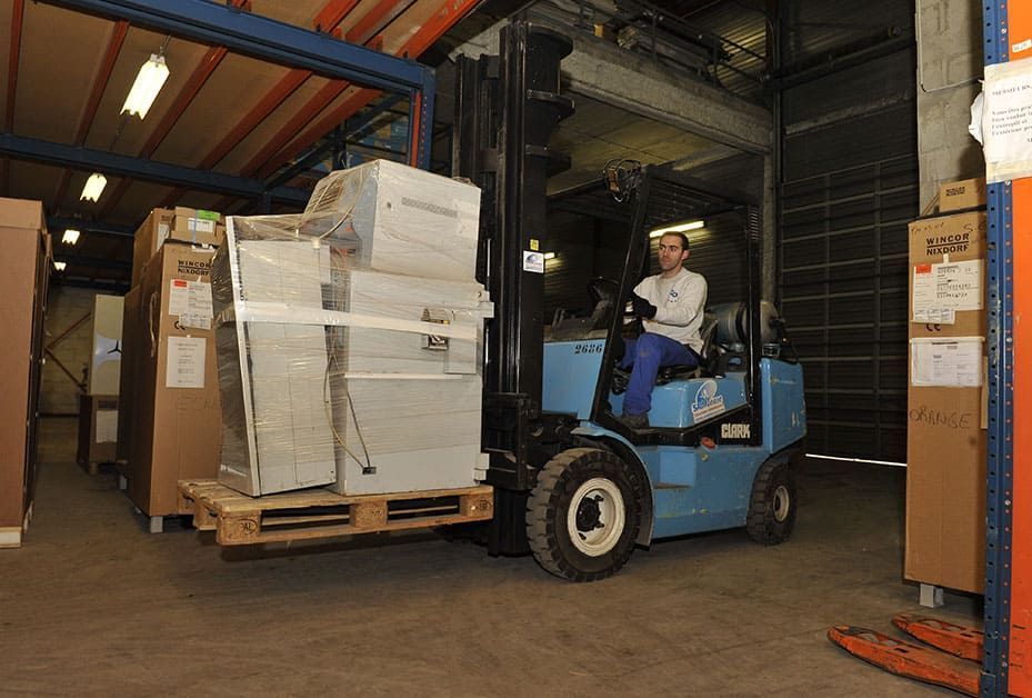 Professionnel conduisant un transpalette.