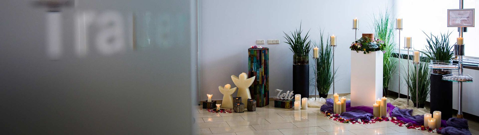 Ein Raum mit vielen Kerzen und Blumen auf dem Boden.